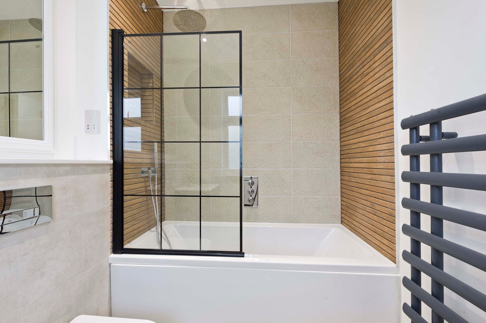 Guest Bedroom Ensuite with wooden walls and crittal bath screen